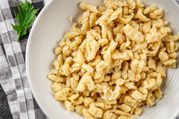 spaetzle egg pasta irregular shape fresh meal food snack on the table copy space food background rustic top view