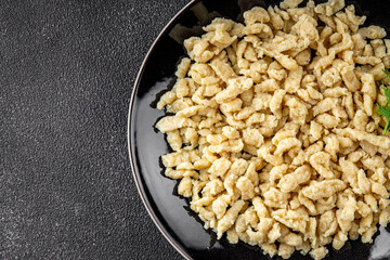 spaetzle egg pasta irregular shape fresh meal food snack on the table copy space food background rustic top view