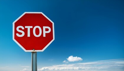 Obraz premium stop sign on blue background space on right of sign