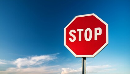 stop sign on blue sky background copy space left of sign 