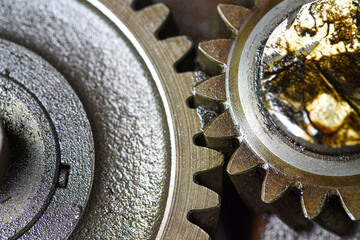 Gear box  of a  small  four  stroke  engine . engine gear wheels  of a gasoline engine .  small four stroke engine gears with oil traces and dirt .