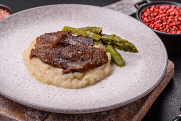 Juicy beef or pork cut into slices with boiled asparagus