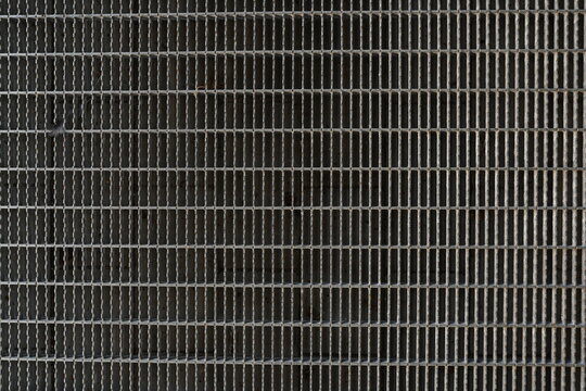 A background image of a gray steel grating panels.