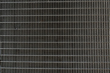 A background image of a gray steel grating panels.