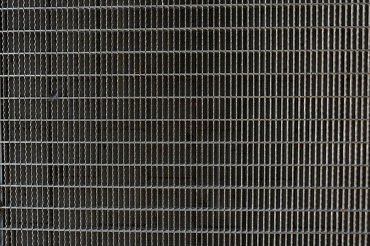 A background image of a gray steel grating panels.