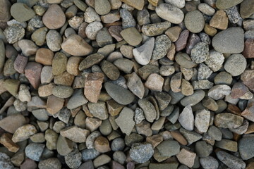 Naklejka premium Processed collage of sea shore pebbles texture. Background for banner, backdrop or texture for 3D mapping