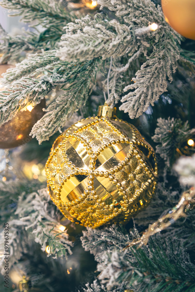 Wall mural Close-up, golden ball on a Christmas tree close-up.