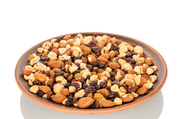 Nut mixture with dry berries on a clay plate, macro, isolated on white background.
