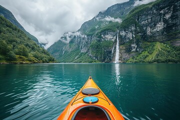 A kayak is in the water with a beautiful view of mountains in the background
