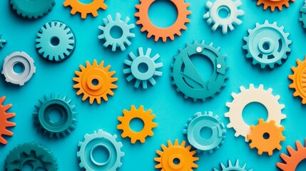 Colorful gears arranged creatively against a blue background, symbolizing teamwork, collaboration, engineering, mechanics, and innovation.