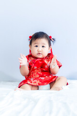 Girl in Chinese New Year costume,Happy Little asian girl in chinese traditional dress laughing and smiling.