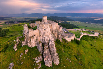 Aerial view of the ruins of Spis Castle and the surrounding area during the summer sunset