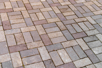 Paving slabs on the street. A path paved with paving slabs. Multi-colored tiles