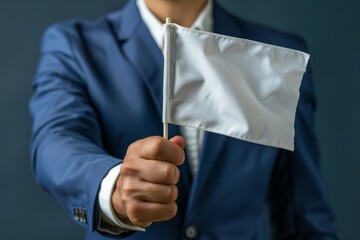 Businessman holding a blank white flag in office
