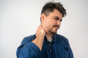 Fototapeta premium Young man suffering from neck pain. Headache pain. Young man suffering from neck pain on light background, side view