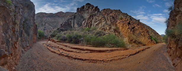 Northern Kyrgyzstan. Picturesque winding trails of the Kok Moinok canyons with red-brown rock along...