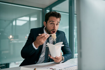 Surprise, business and man for eating in office with computer by reading email, finance report and feedback. Shock, accountant and pc with fast food, noodles and review project of investment growth