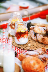 Buns, milk, muesli, cookies at the New Year's breakfast. Table setting for children for the New Year