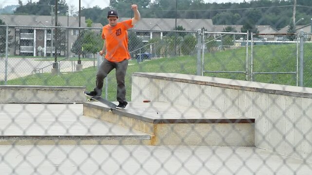 Middle age man exercising by practicing a skateboard trick at an outdoor local skate park apart of a healthy lifestyle 04