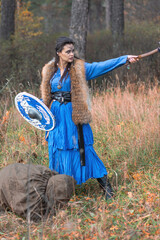 Viking warrior girl in blue in autumn