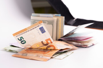 Many banknotes of different currency. Background of big amount of random money bills close up