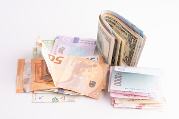 Many banknotes of different currency. Background of big amount of random money bills close up