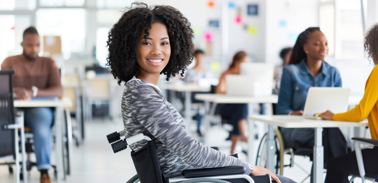 Woman in wheelchair smiling and working in a modern office environment