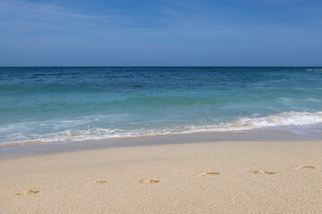 Footprints on a sandy beach on a sunny summer's day
