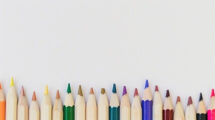 Colored pencils in a row on white background with space for text representing teamwork and motivation