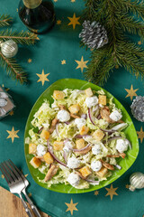 Christmas appetizer New year meal idea. Christmas appetizer. Christmas New Year salad chinese cabbage, feta cheese, chicken and croutons on rustic table.