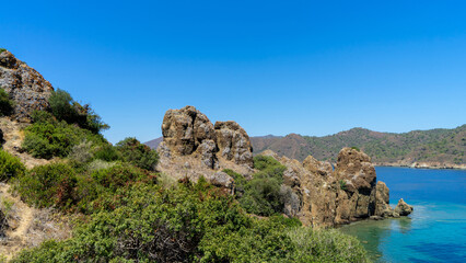 Tooth Island in Aegean Sea, Turkey or island of teeth or Dislice Island. Lava from above looks like open mouth of dragon, from  distance island resembles huge animal teeth. Sea cruises