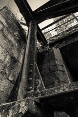 black and white photo of a building with a metal beam sticking out of it