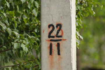 A concrete post with the numbers 