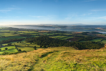 Fototapeta premium A view over woodland and the Shropshire Countryside from the Wrekin hill in Shropshire, UK