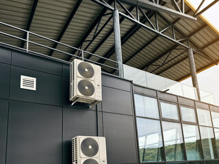 Commercial HVAC system installed on building exterior with glass and steel design