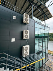 Commercial HVAC system installed on building exterior with glass and steel design
