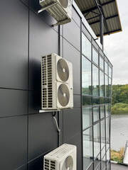 Commercial HVAC system installed on building exterior with glass and steel design