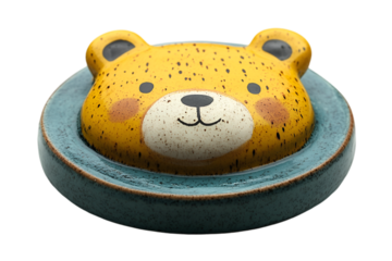 a yellow bear head on a blue plate.