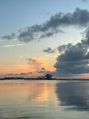 Sunrise overlooking the water and a pier