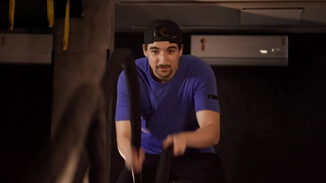 Man Doing CrossFit Rope Exercise for Strength and Health. Man performing a high-intensity rope workout, ideal for fitness and CrossFit training content promoting a healthy and strong lifestyle.
