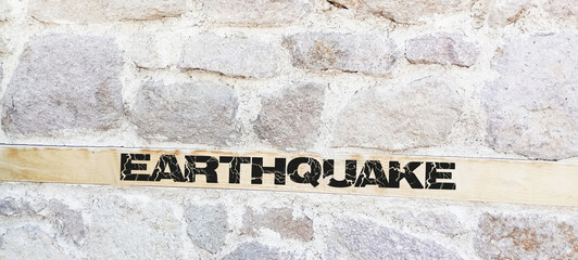 Caution Earthquake Zone Sign on Cracked Rock Background
