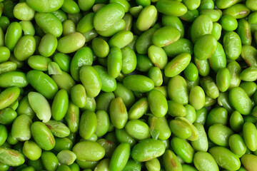 Fresh edamame beans as background, top view