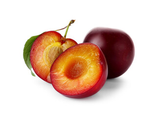 Whole and cut ripe plums isolated on white
