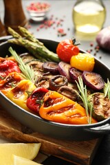 Delicious grilled vegetables in baking dish on table, closeup