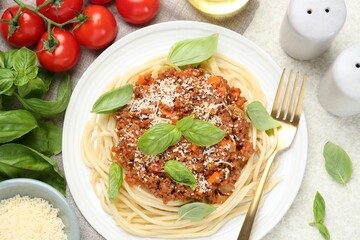 Delicious pasta bolognese served on light table, flat lay