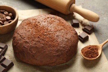Chocolate dough and ingredients on grey table, closeup