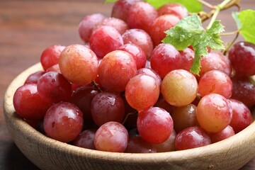 Fresh ripe grapes on wooden table, closeup