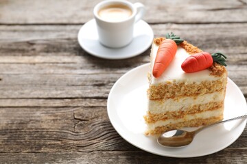 Piece of delicious carrot cake served with coffee on wooden table, closeup. Space for text