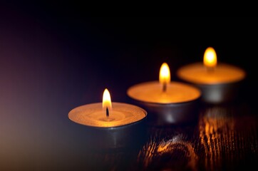 Burning candles surface in darkness background