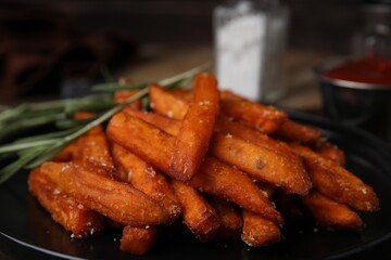 Sweet potato fries and rosemary on table, closeup